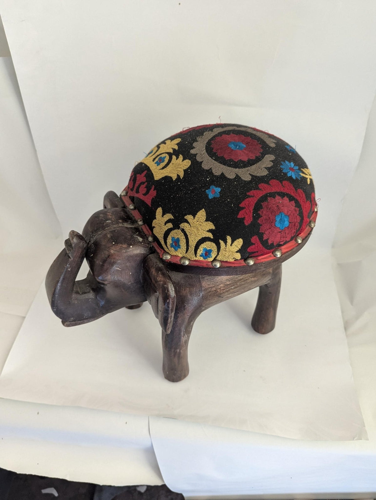 Hand-Carved Wooden Elephant Footstool: Colorful Boho Floral Upholstery - The Relic Detail