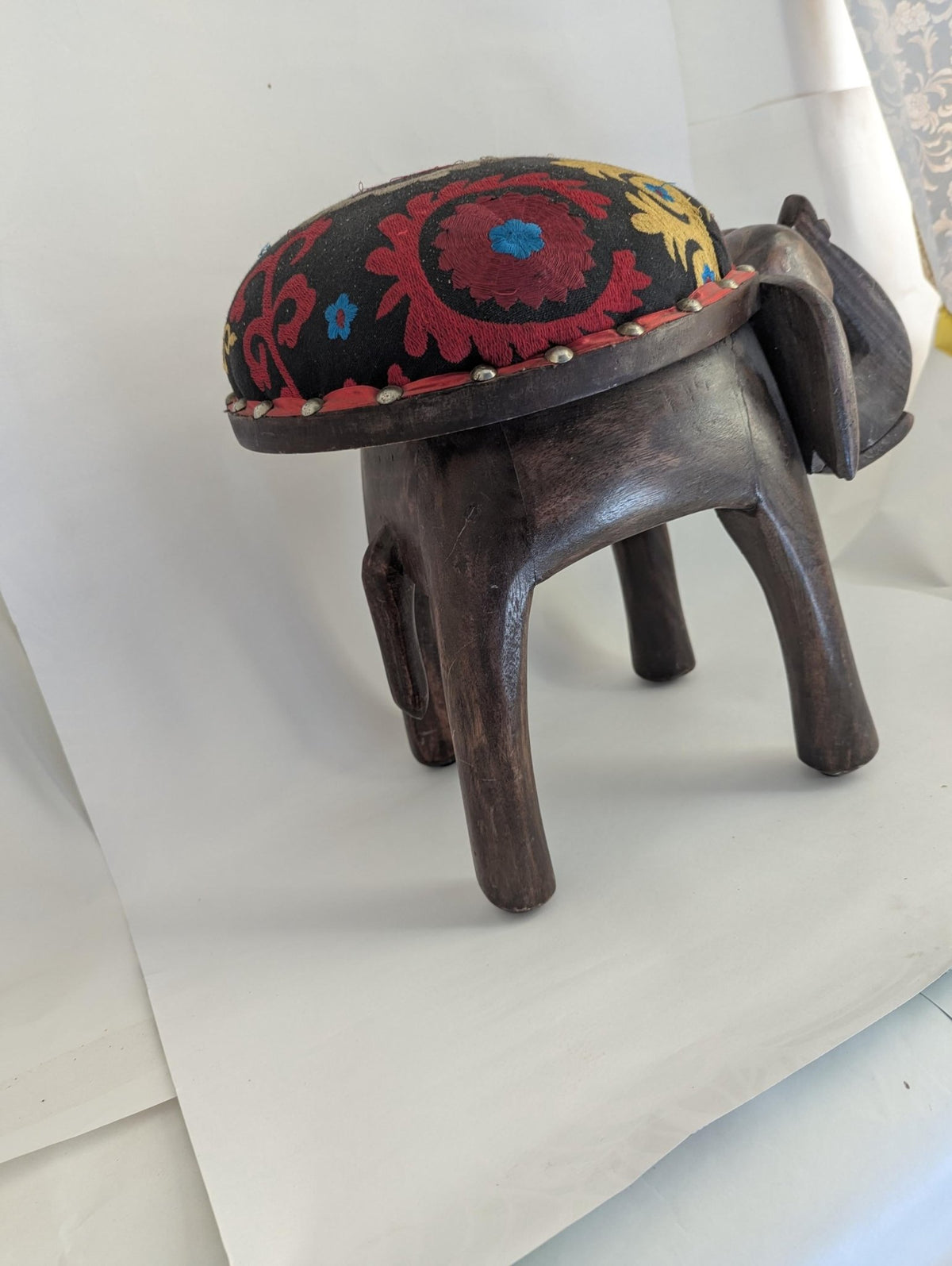 Hand-Carved Wooden Elephant Footstool: Colorful Boho Floral Upholstery - The Relic Detail